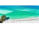 Gorgeous turquoise water meets a pristine white sand beach, perfect for relaxation and recreation at 225 Hourglass Way # 101, Sarasota, FL 34242