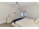 This bedroom is bright and airy, and it features light wood floors and sliding doors leading to the lanai at 225 Hourglass Way # 101, Sarasota, FL 34242