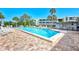 Inviting community pool with ample seating and lush landscaping, perfect for relaxation and socializing at 225 Hourglass Way # 101, Sarasota, FL 34242