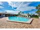 Sparkling community pool featuring ample lounge seating and lush landscaping for relaxation at 225 Hourglass Way # 101, Sarasota, FL 34242