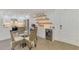 A dining area with modern furnishings, open to kitchen and living room at 225 Hourglass Way # 101, Sarasota, FL 34242