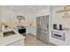 Bright kitchen with new stainless steel appliances and white cabinetry at 225 Hourglass Way # 101, Sarasota, FL 34242