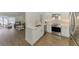 Beautiful kitchen with white cabinetry opens to the bright and spacious living area at 225 Hourglass Way # 101, Sarasota, FL 34242