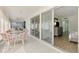 This spacious lanai has a glass table and seating, offering an inviting space to relax and enjoy the view at 225 Hourglass Way # 101, Sarasota, FL 34242