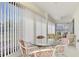 The comfortable lanai features window blinds and casual seating, perfect for relaxing and enjoying the view at 225 Hourglass Way # 101, Sarasota, FL 34242