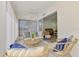 The bright and open lanai features cozy seating and a ceiling fan, perfect for relaxing with Gathering and friends at 225 Hourglass Way # 101, Sarasota, FL 34242
