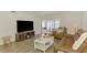Comfortable living room open to sunroom, great for entertaining or relaxing at 225 Hourglass Way # 101, Sarasota, FL 34242
