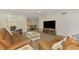 Open living area with TV and dining area in the background; comfortable furniture at 225 Hourglass Way # 101, Sarasota, FL 34242