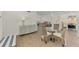 An open concept living room and dining area with wicker furniture at 225 Hourglass Way # 101, Sarasota, FL 34242