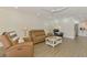Spacious living room with recessed lighting open to kitchen; modern and comfortable at 225 Hourglass Way # 101, Sarasota, FL 34242