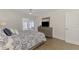 Bright main bedroom with ceiling fan and dresser; sliders open to sunroom at 225 Hourglass Way # 101, Sarasota, FL 34242