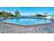 Community pool with a clear view of the beach and the gulf at 225 Hourglass Way # 101, Sarasota, FL 34242