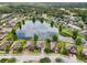 Aerial view of a residential community surrounding a beautiful lake with lush landscaping at 2254 50Th Street E Cir, Palmetto, FL 34221
