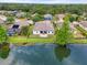 Aerial view of a lakefront property with a fenced yard and mature trees at 2254 50Th Street E Cir, Palmetto, FL 34221