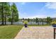 Scenic backyard view featuring a paved patio overlooking a tranquil pond with a fountain feature at 2254 50Th Street E Cir, Palmetto, FL 34221