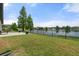 Large, grassy backyard fenced with black aluminum with patio area overlooking the water at 2254 50Th Street E Cir, Palmetto, FL 34221