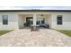 Rear elevation view of the house highlighting the brick paver patio and covered sitting area at 2254 50Th Street E Cir, Palmetto, FL 34221