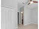 Neutral bedroom featuring light hardwood floors, white closet doors, and a ceiling fan at 2254 50Th Street E Cir, Palmetto, FL 34221
