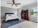 Beautiful bedroom featuring a large ceiling fan, ample natural light, and a decorative bookcase at 2254 50Th Street E Cir, Palmetto, FL 34221