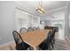 Open dining area with wooden table and chairs, flowing into the living room and kitchen for easy entertaining at 2254 50Th Street E Cir, Palmetto, FL 34221