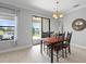 Charming dining room offers views of a lake with sliding glass doors at 2254 50Th Street E Cir, Palmetto, FL 34221