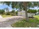 Suburban home with paver driveway and lush landscaping featuring palm trees at 2254 50Th Street E Cir, Palmetto, FL 34221