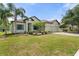 Beautiful single-story home showcasing a well-manicured lawn and a three-car garage at 2254 50Th Street E Cir, Palmetto, FL 34221