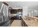 Modern kitchen features stainless steel appliances, granite countertops, and dark wood cabinetry at 2254 50Th Street E Cir, Palmetto, FL 34221