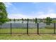 Scenic view of the lake from the backyard of the property, framed by a black aluminum fence at 2254 50Th Street E Cir, Palmetto, FL 34221