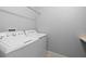 Functional laundry room with side-by-side white washer and dryer at 2254 50Th Street E Cir, Palmetto, FL 34221