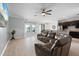 Open living room features tile floors, ceiling fan, and view to kitchen at 2254 50Th Street E Cir, Palmetto, FL 34221