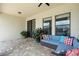 This covered patio boasts pavers, access to the home, a ceiling fan, and comfortable seating at 2254 50Th Street E Cir, Palmetto, FL 34221
