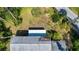 Aerial view of a well-maintained home with a gray roof surrounded by lush greenery at 2511 Lords Ln, Sarasota, FL 34231