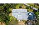 Aerial view of a well-maintained home with a gray roof surrounded by lush greenery at 2511 Lords Ln, Sarasota, FL 34231
