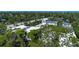 Serene aerial view of property with lush trees, bridge, and waterway at 2511 Lords Ln, Sarasota, FL 34231
