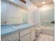 Bright bathroom with a blue countertop, white cabinets and a shower with light blue tile at 2511 Lords Ln, Sarasota, FL 34231