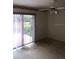 This bedroom features a ceiling fan and sliding doors to the outside at 2511 Lords Ln, Sarasota, FL 34231