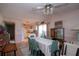Dining area features aqua chairs, white tablecloth, and seamlessly connects to an open-concept kitchen at 2511 Lords Ln, Sarasota, FL 34231