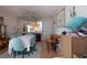 Dining room with aqua chairs and a light-colored tablecloth with a glimpse of the kitchen through mirrored wall at 2511 Lords Ln, Sarasota, FL 34231