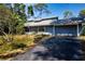 Inviting single-story home with an attached garage and a comfortable front porch at 2511 Lords Ln, Sarasota, FL 34231