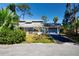 Inviting home with lush greenery and cozy chairs on the front porch at 2511 Lords Ln, Sarasota, FL 34231