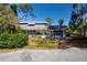 Quaint single-story home with mailbox, lush greenery, and driveway at 2511 Lords Ln, Sarasota, FL 34231