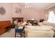 Living room with fireplace, vaulted ceilings, seating, and large painting at 2511 Lords Ln, Sarasota, FL 34231