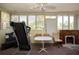 Sunroom with multiple windows, a ceiling fan, and a fireplace, with space to create a gym area at 2511 Lords Ln, Sarasota, FL 34231