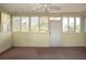 The sunroom has an abundance of windows, a ceiling fan, and plenty of natural light at 2511 Lords Ln, Sarasota, FL 34231