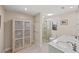 Elegant bathroom features marble countertops, glass enclosed shower, and ample storage at 2778 Greendale Dr, Sarasota, FL 34232