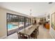 Elegant dining room boasts an inviting view of the sparkling pool and expansive outdoor entertainment area at 2778 Greendale Dr, Sarasota, FL 34232