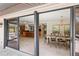 Open-concept dining room with tile flooring, decorative chandelier, and access to outdoor area at 2778 Greendale Dr, Sarasota, FL 34232