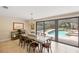 Formal dining area with views of the screened-in pool and backyard at 2778 Greendale Dr, Sarasota, FL 34232