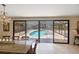 Dining room with a view of the screened-in pool area and outdoor seating at 2778 Greendale Dr, Sarasota, FL 34232